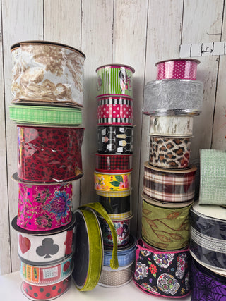 Collection of colorful ribbon spools on a wooden surface