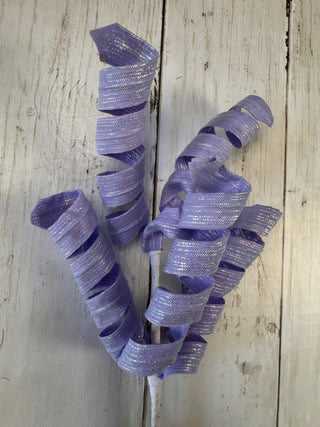 Purple decorative bow on a wooden surface