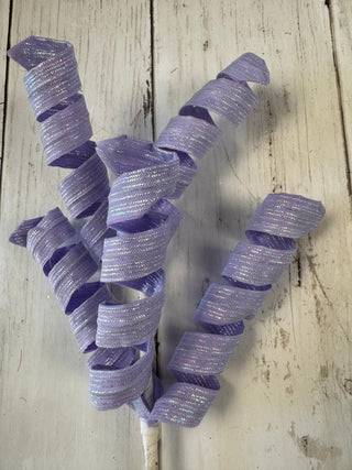 Purple ribbons on a light wooden surface