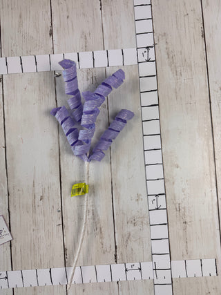 Purple ribbons on a white tile with a yellow square and white string